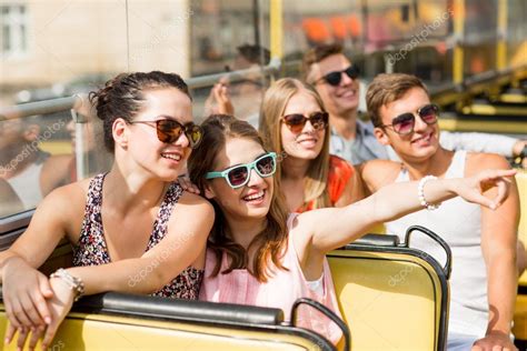 Group Of Smiling Friends Traveling By Tour Bus Stock Photo By ©syda