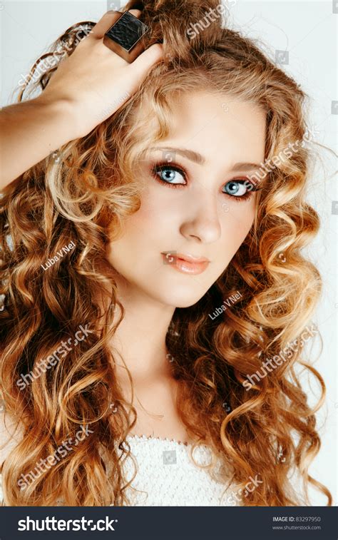 Beautiful Strawberry Blond Woman With Blue Eyes And Long Big Curly Hair