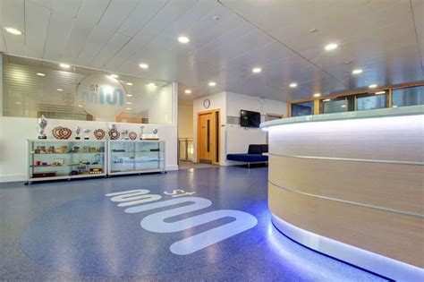 A School Reception Area With Curved Desk And Led Lighting Interior