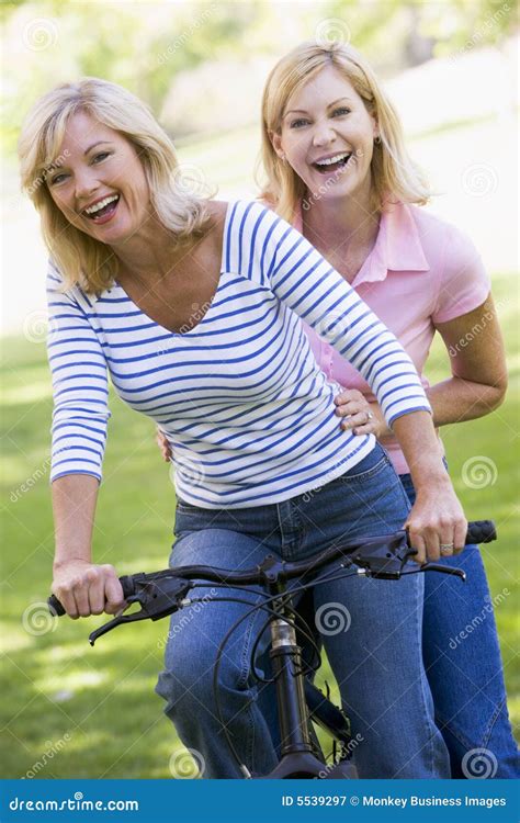 Two Friends On One Bike Outdoors Smiling Stock Image Image Of