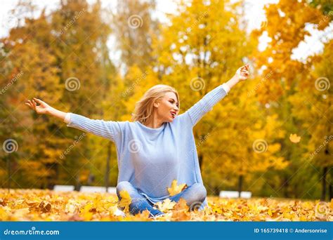 Portrait Of Young Blonde Beautiful Woman In Autumn Park Stock Photo