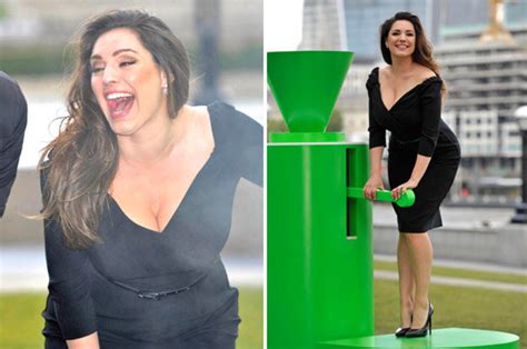 Kelly Brook Embraces Pin Up Persona As Cleavage Spills From Frock