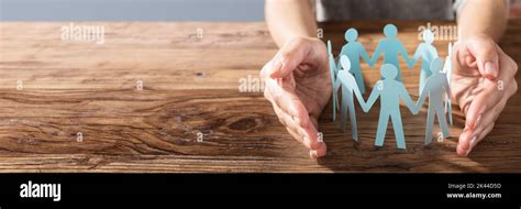 Employee Hands Protecting Cutout Paper People Equal Human Concept