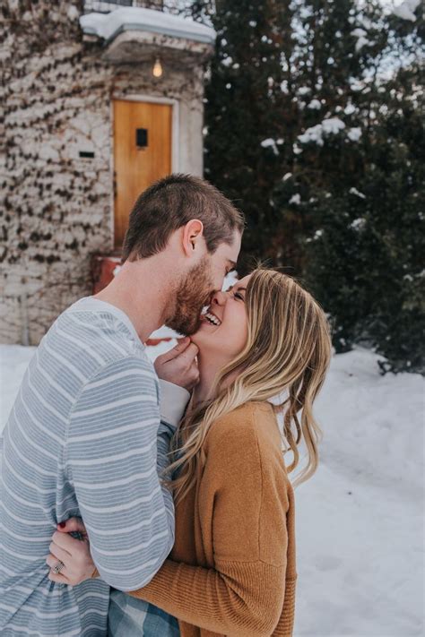 Engagement Session Winter In The Snow Cuddling Sweaters Photos By Abbey Armstrong Photography