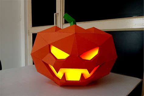 An Origami Pumpkin With Glowing Eyes And Mouth