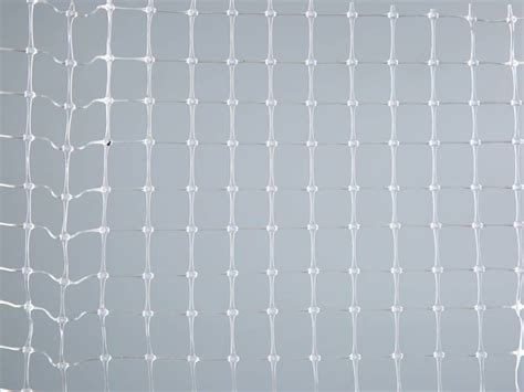 A Piece Of Transparent Plastic Mesh On The Gray Background Plastic