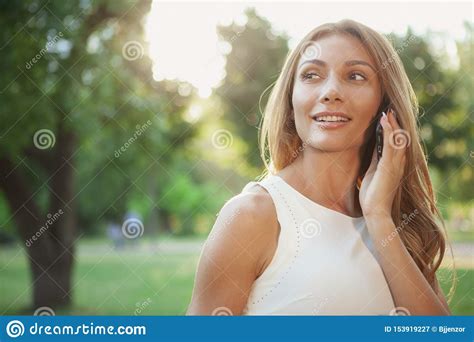 Beautiful Woman Talking On The Phone Outdoors Stock Image Image Of Beautiful Device 153919227