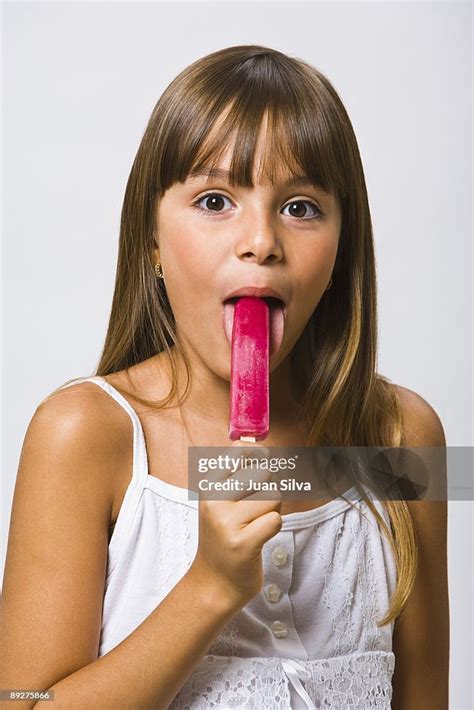 Girl Eating A Popsicle Portrait High Res Stock Photo Getty Images