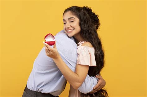Happy Indian Lady With Engagement Ring Embracing Her Future Husband Saying Yes To His Marriage