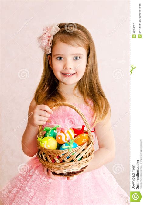 Little Girl With Basket Full Of Colorful Easter Eggs Stock Image