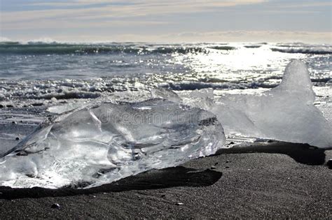 Large Pieces Of Iceberg On Black Sand Beach In Iceland Stock Photo