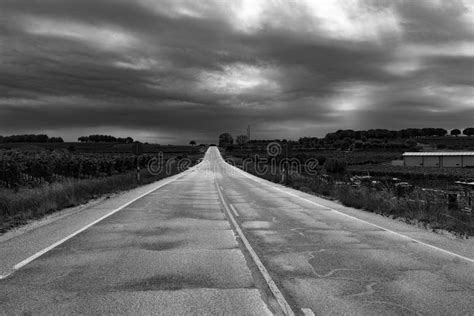 Straight Road Under Clouds In Black And White Stock Photo Image Of