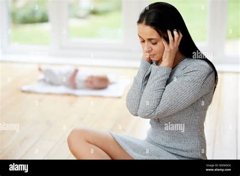 Mother Looking Stressed Out With Her Baby Stock Photo Alamy
