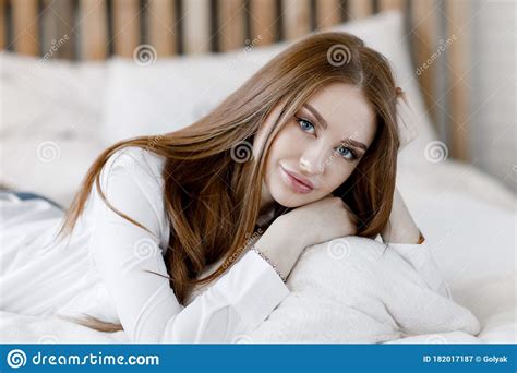 Beautiful Young Woman With Long Hair Posing For The Camera At Home