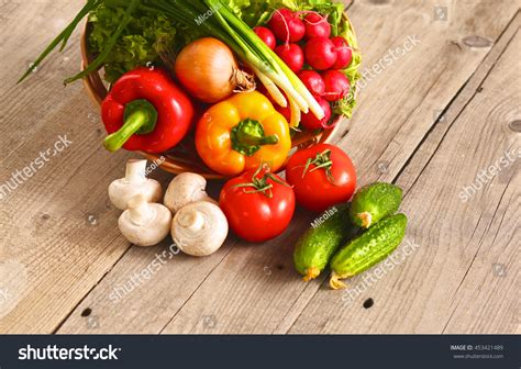 Fresh Vegetables On A Clean Wooden Table Stock Photo 453421489