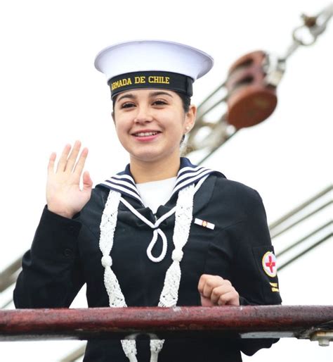 A Woman In A Sailors Uniform Waves To The Crowd