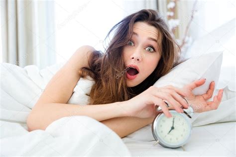 Shocked Woman Waking Up With Alarm — Stock Photo © Vadymvdrobot 96236384