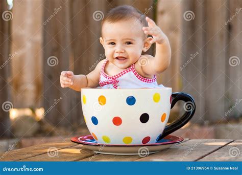 Happy And Cute Baby Girl In Giant Teacup Royalty Free Stock Image
