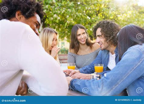 Multi Ethnic Group Of Friends Having A Drink Together In An Outdoor Bar Stock Image Image Of