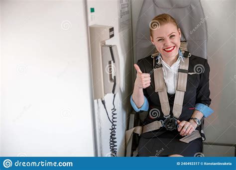 Cheerful Stewardess Doing Thumbs Up Gesture In Airplane Cabin Stock Image Image Of Plane