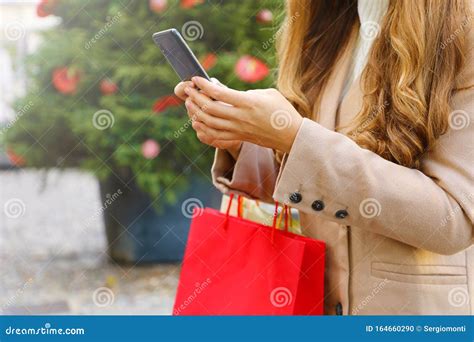 Shopper Woman Carrying Bags Using Smart Phone For Shopping Online On