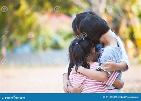 Group Of Asian Children Hugging And Playing Together Stock Photo