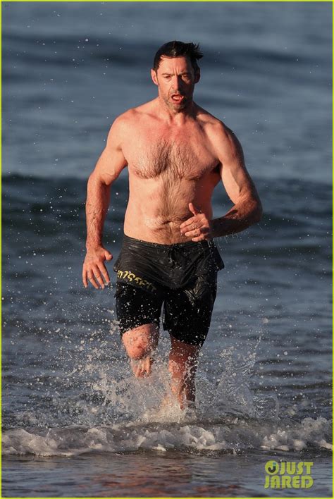 Hugh Jackman Runs Shirtless On The Beach With His Ripped Muscles On