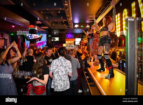 Inside A Coyote Ugly Bar Where Women Dance On The Bar As People Order Drinks Inspired By The
