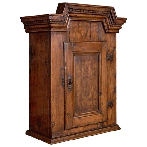 Hanging on the wall, this crate transforms into a beautiful wooden shelf system and includes four hooks along the bottom for extra organization. Small Antique Hanging Wall Cabinet from Denmark For Sale at 1stdibs