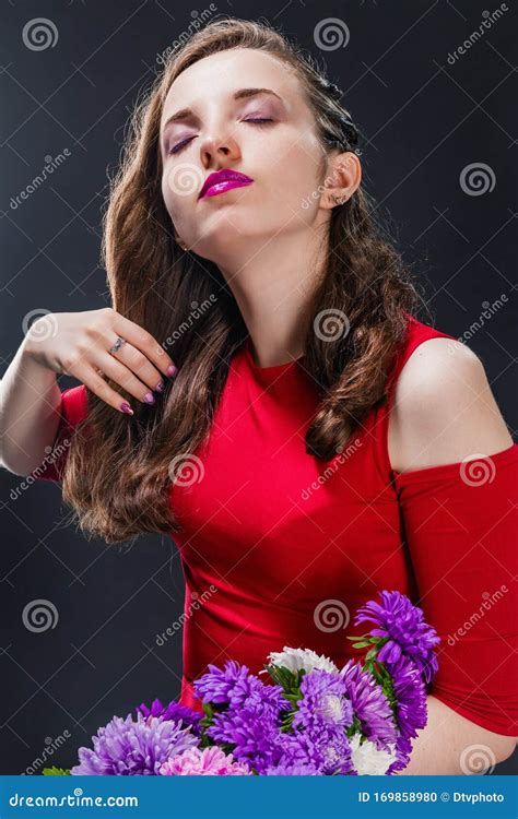 Stylish Beautiful Passionate Girl With Purple Asters On Dark Background