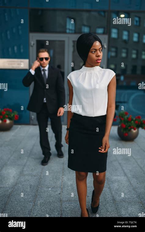 Black Business Woman Bodyguard In Suit And Sunglasses On Background