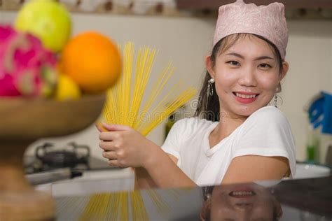 Attractive And Happy Asian Woman Preparing Noodles Domestic Lifestyle Portrait Of Young Sweet