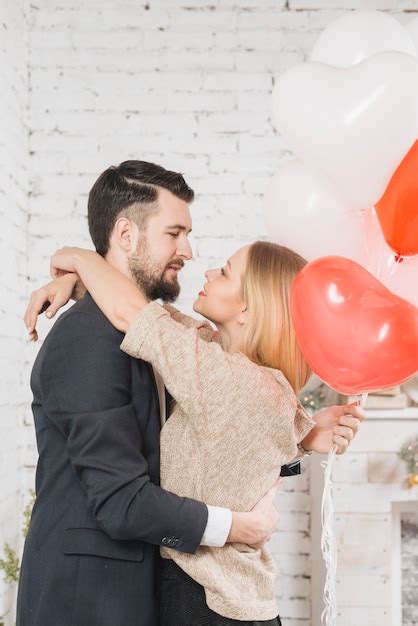 Free Photo Caressing Couple With Balloons In Embrace