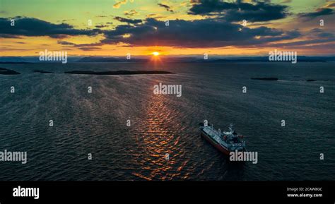 Sunrise Over The Sea Bay With A Ship At Anchor Stock Photo Alamy
