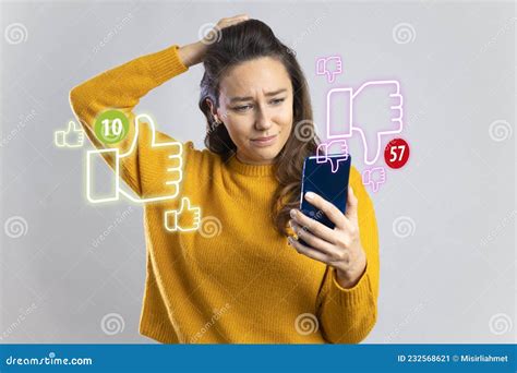 Young Woman Holding Mobile Phone Looking Too Much Dislikes On Her Social Media Post Stock Image