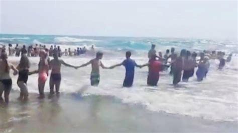 40 Strangers Form Chain To Rescue Swimmers On Lake Michigan YouTube