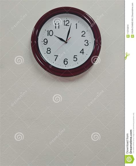 A Clock On The Wall Shows The Current Time Is 1002 Stock Image