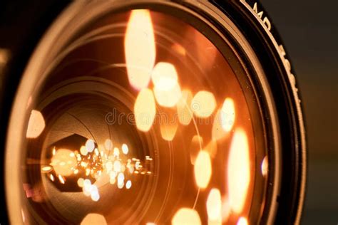Closeup Shot Of The Golden Lights In The Camera Lens Stock Image