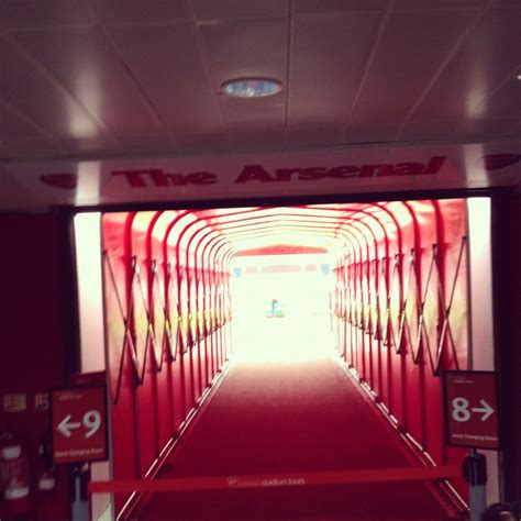 The Entrance To An Airport With Red Carpeting And White Walls Leading