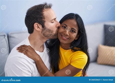 Man And Woman Interracial Couple Hugging Each Other And Kissing At Home