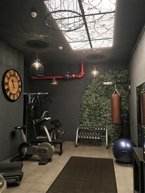 A Home Gym With Exercise Equipment And An Indoor Wall Mounted Clock