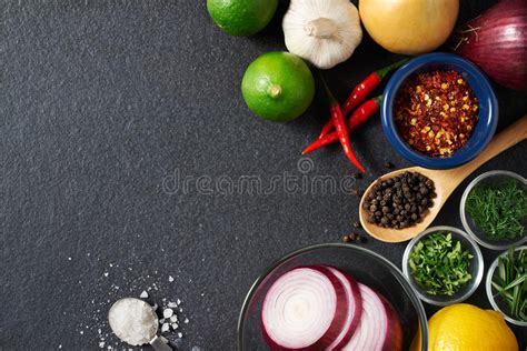 Different Spices And Herbs On Black Stone Table Top View Ingredients