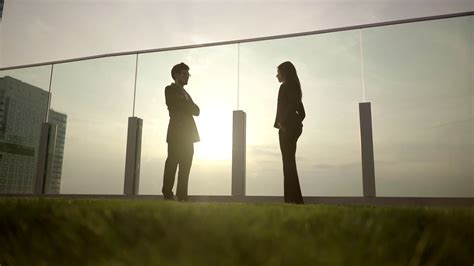 sunset shadow view of two people standing talking together Stock Video Footage - Storyblocks