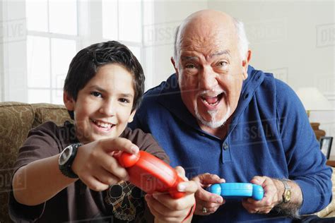 Grandfather And Grandson Playing Video Games Stock Photo Dissolve