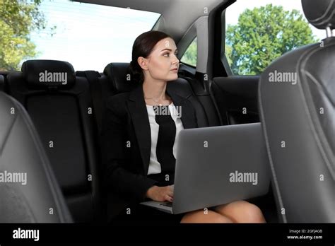 Beautiful Woman With Laptop In Car Stock Photo Alamy