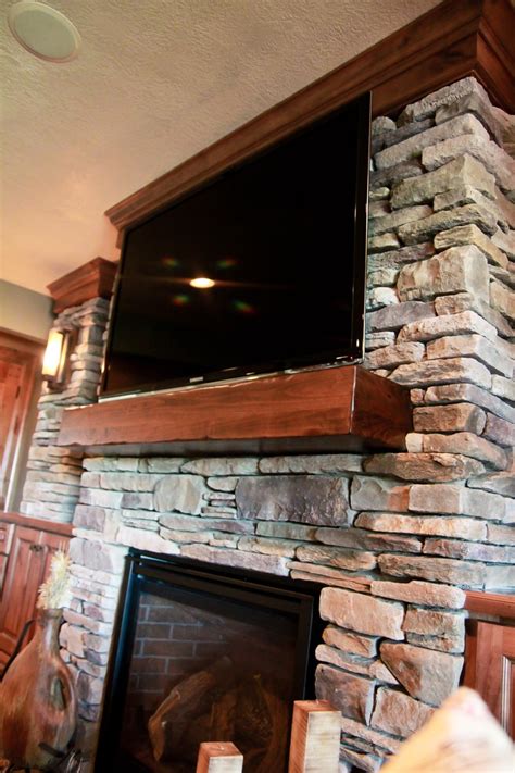 You can either cover the space between the 2 mantels with wood or not. Stone fireplace surround, wood mantle, TV over fireplace ...