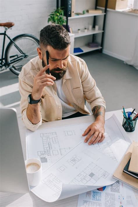 Male Architect Sitting And Looking At Blueprints Stock Photo Image Of