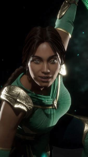 An Image Of A Woman In Green And Gold Outfit With Her Arm Raised Above Her Head