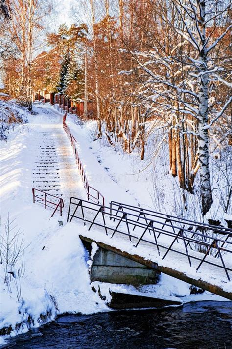 A Bridge Over A Small River A Majestic Winter Landscape Shining With
