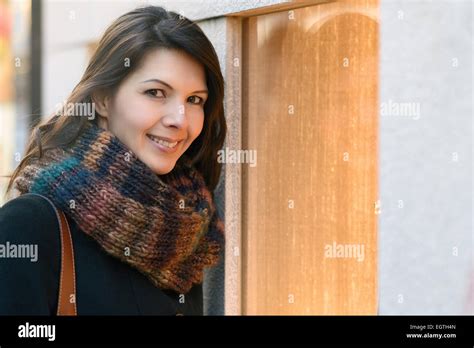 Brunette Attractive Woman Shopping In Winter In Front Of A Store